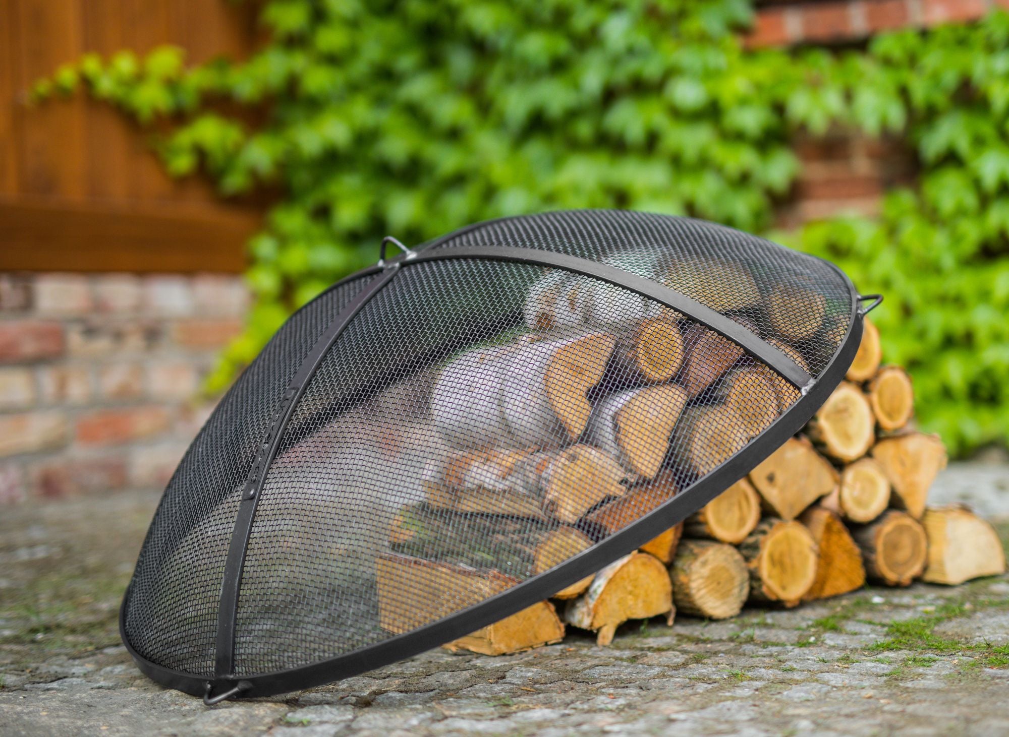 Cook King 59 cm Fire Bowl Mesh Spark Screen in an outdoor setting