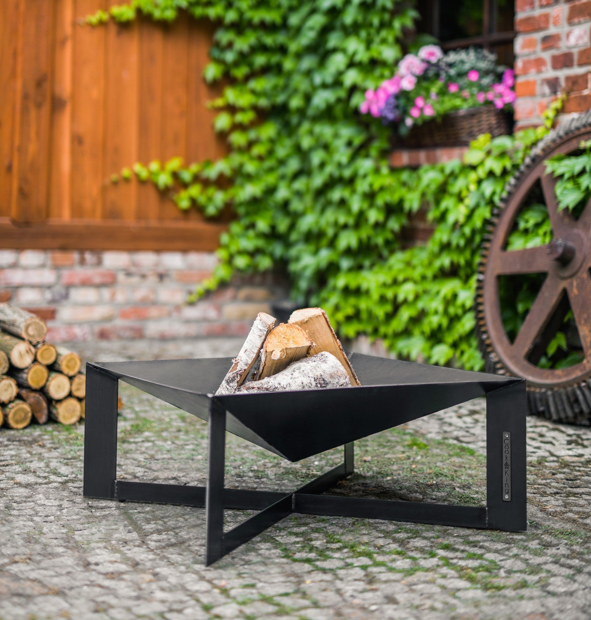 Cook King Cuba 70x70cm Fire Bowl in an outdoor setting