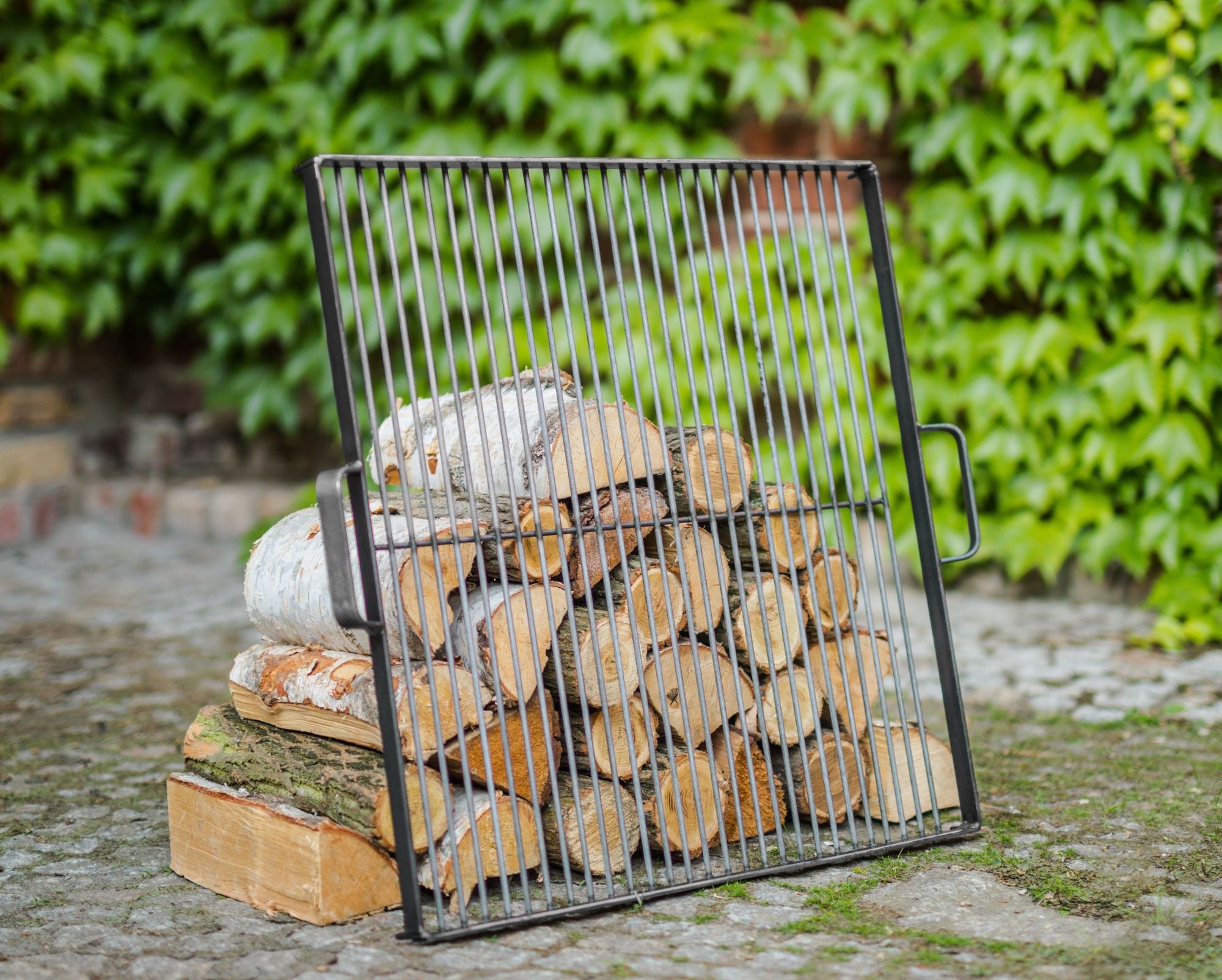 Cook King 44x44 cm Natural Steel Grate for 60 cm Fire Bowl in an outdoor setting