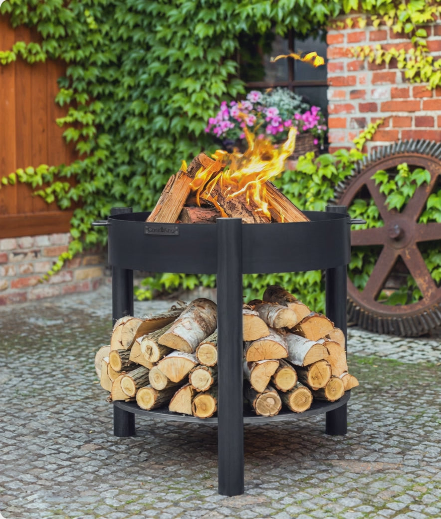 Cook King Set: MONTANA 80 cm Tall Garden Fire Bowl with 82 cm Lid burning in a garden setting